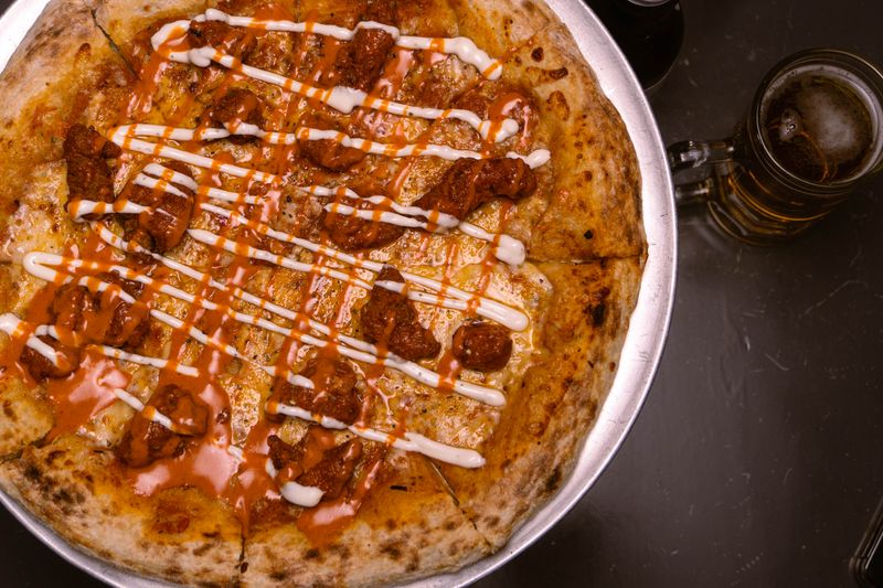 BBQ chicken punch pizza with caramelized onions and cilantro